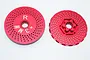 Two red anodized aluminium RC wheel hex adapters with a perforated disc design, showing front and back views.