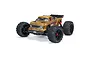ARRMA Outcast 4S BLX stunt truck in bronze finish, featuring large off-road tires, a rear wing, and detailed body decals on a white background.