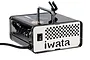 Iwata Ninja Jet airbrush compressor in black with a silver front panel, featuring a carry handle and airbrush holder.
