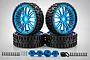 A set of four Rovan 6.5 inch all-terrain RC wheels with black knobby tires and bright blue multi-spoke rims, including hex adapters and mounting hardware.