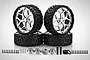A set of four Rovan 6-inch all-terrain RC wheels with silver rims and black tires, including hex adapters, pins, and mounting hardware.