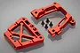 A set of Rovan red anodized aluminium rear bulkhead parts with four black mounting screws on a grey background.