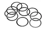 A collection of ten thin, flat, circular metal washers arranged in a scattered pile against a white background.