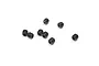 A small group of seven black metal grub screws with hexagonal sockets, scattered on a plain white background.