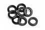 A pile of eight black rubber X-rings for RC car shock absorbers on a white background.