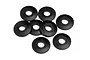 A top-down view of eight black plastic washers arranged in a loose cluster against a white background.