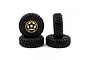 A set of four RC crawler wheels with black rubber tires and gold-rimmed five-spoke wheels with graphite centers, arranged on a white background.