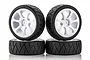 Four Team Powers 1/10 scale touring car wheels with white plastic rims and black treaded radial rubber tyres arranged in a stack.