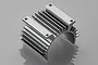 A silver aluminium motor heat sink with cooling fins and mounting holes for a cooling fan, shown against a light grey background.