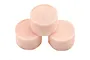 Three cylindrical pink foam air filter inserts arranged in a triangular formation against a white background.