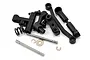 A collection of black plastic steering bellcrank components, metal pins, screws, and small washers for a LaTrax RC vehicle.