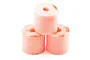 Three cylindrical pink foam air filters stacked in a pyramid formation against a white background.