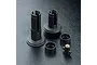 A set of black MST RC differential joint parts including two drive cups, two spacer rings, and a small threaded cross-pin component.