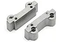 Two grey cast aluminium engine mount pieces for an RC car, shown from an elevated angle against a white background.