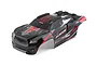 A pre-painted red and black Traxxas Sledge RC truck body shell with decals, viewed from a high angle against a white background.