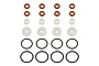 A set of RC shock rebuild components including orange o-rings, white plastic spacers, and black rubber o-rings arranged in rows on a white background.