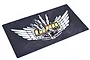 A rectangular GPM Racing pit mat with a black textured background and a large white-winged logo with gold lettering.
