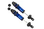 Two blue anodized aluminum Traxxas GT-Maxx long shock absorbers with black plastic components and two small black shock pistons on a white background.