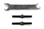 Two black metal turnbuckles and one silver metal wrench on a white background.