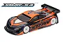 A studio shot of an XRAY X4 1/10 scale electric touring car with a custom orange and black painted body shell and white wheels on a white background.