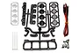 Team Associated XP LED roof light kit components including plastic light housings, lenses, wire harness with four LEDs, zip ties, and mounting screws.