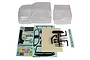 An unpainted clear polycarbonate RC truck body shell with a separate bed section, decal sheets, and a sprue of black plastic scale accessories.