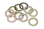 A group of ten gold-colored metal washers scattered on a white background.