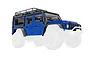 A blue Traxxas Land Rover Defender RC body shell with a black roof rack and exoskeleton, shown against a white background.