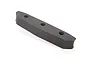 A grey foam body bumper for an RC car, featuring three circular mounting holes, isolated against a white background.