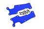 Two blue plastic front suspension arm covers for an RC car with a set of small black mounting screws on a white background.