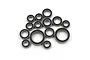 A collection of various sized rubber shielded ball bearings for RC vehicles arranged on a white background.