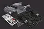 Rovan 1/5 scale clear unpainted body shell and black plastic roll cage kit with decal sheet on a dark background.