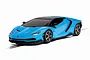 A 1/32 scale Scalextric Lamborghini Centenario slot car in bright blue with black accents, shown from a front three-quarter angle on a white background.