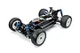 A high-angle studio shot of the Tamiya TT-02BR 1/10 scale RC buggy chassis, showing the black plastic frame, blue anodized shocks, and off-road tires.