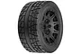 Pro-Line Menace HP belted monster truck tyre pre-mounted on a black Raid wheel, viewed from a three-quarter angle.