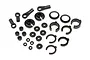 A collection of black plastic RC shock absorber spare parts including ball ends, spring retainers, spacers, and clips on a white background.