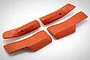 A set of four bright orange rubberized grip covers for a Spektrum iX14 RC transmitter, featuring textured surfaces and molded logos.