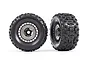 Two Traxxas 3.8 inch Sledgehammer RC monster truck tires pre-glued onto black and grey modular wheels, shown from front and angled views.