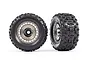 Two Traxxas Sledgehammer 3.8 inch RC monster truck tires mounted on satin black chrome modular wheels against a white background.