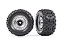Two Traxxas 3.8 inch Sledgehammer tires pre-mounted on satin chrome modular wheels against a white background.