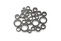 A collection of various sized metal ball bearings with black rubber seals, arranged in a pile on a white background.