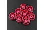 A set of eight fluorescent pink narrow RC car rims arranged on a dark textured surface.
