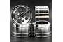 Four silver aluminium RC car rims with an 8-spoke design stacked against a dark background.