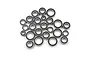 A collection of various sized metal ball bearings with black rubber seals, arranged in a pile on a white background.