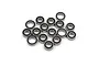 A collection of small metal ball bearings with black rubber seals scattered on a white background.