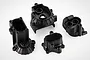 Four black plastic RC gearbox case components arranged on a white background.