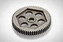 A grey metal 64T spur gear for an RC car, featuring a pentagonal cutout pattern with five circular holes and a central mounting hole.
