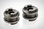 Two grey metal RGT transmission sliders with a hexagonal center hole and notched top profile, shown against a white background.