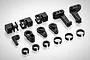 A collection of black plastic RC servo parts including servo horns, mounts, and C-clips arranged on a white background.