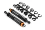 Two HPI Racing RC buggy rear shock absorbers with black springs and orange collars, accompanied by a plastic tree of shock preload spacers.